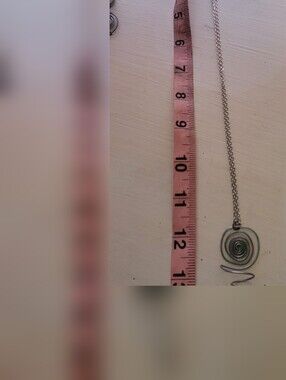 Handmade Spiral Flower Holding Pendant On Silver Chain